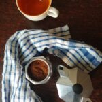 Moka pot with coffee and cup