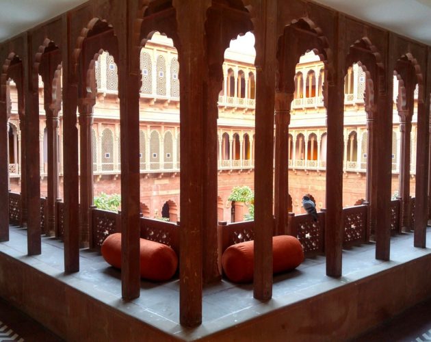 Curved arches and intricate jaalis along the corridors at Narendra Bhawan