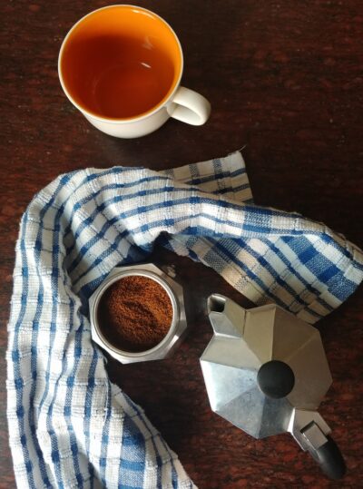 Moka pot with coffee and cup