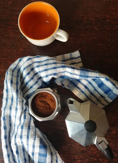 Moka pot with coffee and cup