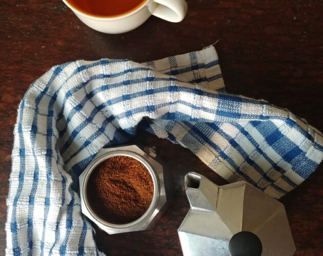 Moka pot with coffee and cup