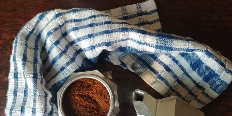 Moka pot with coffee and cup