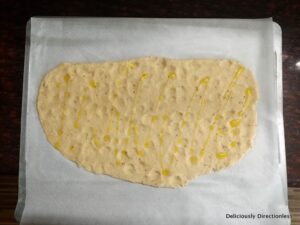 Flatbread drizzled with olive oil and ready to go into the oven