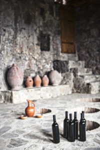 Georgian wines with Qvevri in the background 