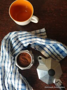 Moka pot with coffee and cup